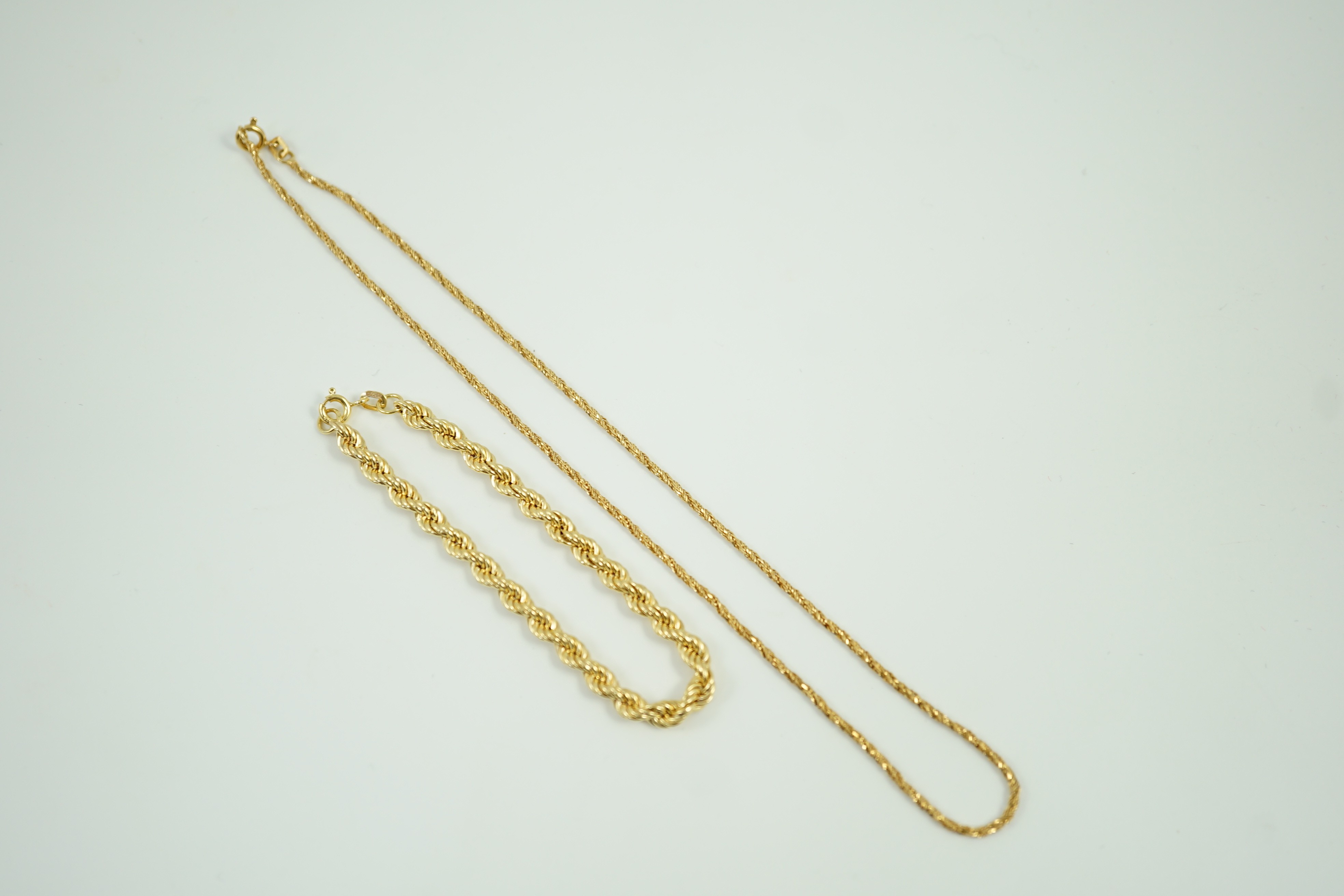 A 750 yellow metal chain, 39cm, 6.1 grams and a 9ct gold rope twist bracelet, 18cm, 3.3 grams.